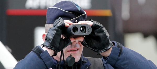 A policeman uses binoculars as he secures the hundreds of thousands of French citizens solidarity march A policeman uses binoculars as he secures the hundreds of thousands of French citizens solidarity march - Sputnik International