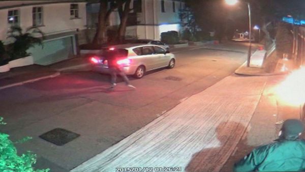A screen grab of CCTV camera footage shows a security guard looking on as a firebomb explodes at the gate after an unidentified person wearing a mask threw it towards Hong Kong media tycoon Jimmy Lai's home in Hong Kong early January 12, 2015. - Sputnik International