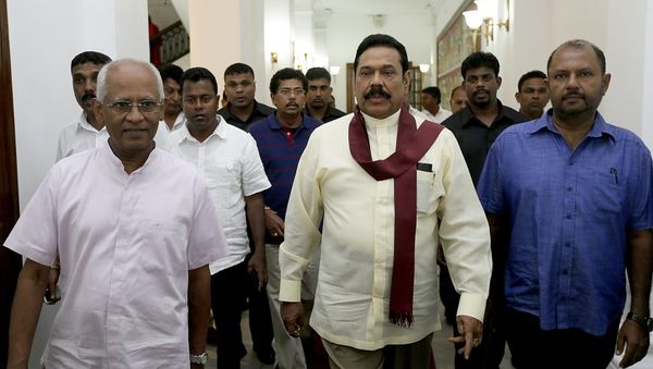 In this hand out photograph received from the President’s Office on January 9, 2015 outgoing president Mahinda Rajapakse (C) leaves his office in the capital Colombo In this hand out photograph received from the President’s Office on January 9, 2015 outgoing president Mahinda Rajapakse (C) leaves his office in the capital Colombo - Sputnik International