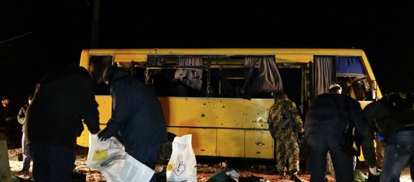 Investigators work at the site were a passenger bus was damaged by shelling, at a checkpoint of the Ukrainian forces in the village of Bugas, near the town of Volnovakha in Donetsk region, eastern Ukraine Investigators work at the site were a passenger bus was damaged by shelling, at a checkpoint of the Ukrainian forces in the village of Bugas, near the town of Volnovakha in Donetsk region, eastern Ukraine - Sputnik International