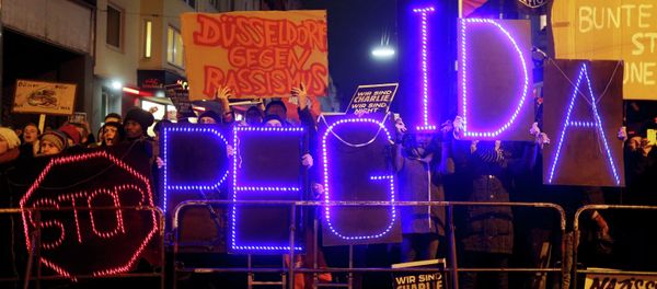 Protesters take part in an anti-racism demonstration against the anti-immigration movement Patriotic Europeans Against the Islamisation of the West (PEGIDA) in Duesseldorf, January 12, 2015 Protesters take part in an anti-racism demonstration against the anti-immigration movement Patriotic Europeans Against the Islamisation of the West (PEGIDA) in Duesseldorf, January 12, 2015 - Sputnik International