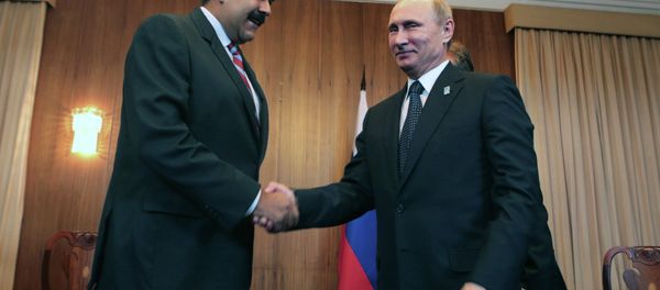 Handout picture released by the Venezuelan Presidential Press office showing Venezuela's President Nicolas Maduro (L) and Rusia's President Vladimir Putin (R) during a bilateral meeting within the BRICS-UNASUR Summit in Brasilia on July 16, 2014 Handout picture released by the Venezuelan Presidential Press office showing Venezuela's President Nicolas Maduro (L) and Rusia's President Vladimir Putin (R) during a bilateral meeting within the BRICS-UNASUR Summit in Brasilia on July 16, 2014 - Sputnik International
