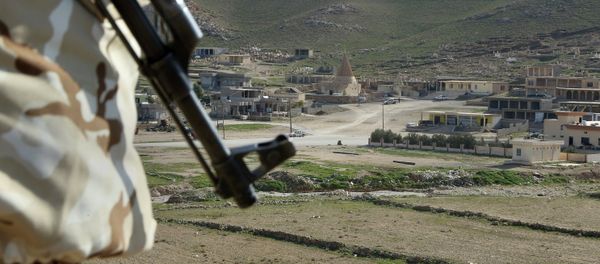 In this Sunday Jan. 11, 2015 photo, a Yazidi fighter protects the Sharaf al-Deen temple shrine, one of the holiest for the Yazidis, a religious minority whom the Islamic State group considers heretics ripe for slaughter, in Sinjar, northern Iraq In this Sunday Jan. 11, 2015 photo, a Yazidi fighter protects the Sharaf al-Deen temple shrine, one of the holiest for the Yazidis, a religious minority whom the Islamic State group considers heretics ripe for slaughter, in Sinjar, northern Iraq - Sputnik International