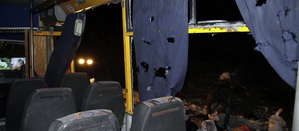 Bodies (R) are laid out next to a damaged bus hit during shelling apparently aimed at a checkpoint manned by Ukrainian forces in Volnovakha, in the eastern Donetsk region Bodies (R) are laid out next to a damaged bus hit during shelling apparently aimed at a checkpoint manned by Ukrainian forces in Volnovakha, in the eastern Donetsk region - Sputnik International
