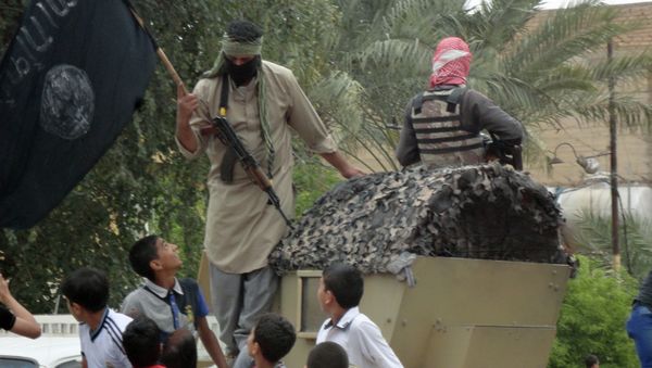 Anti-government fighters, one holding a Jihadist flag, are accompanied by Iraqi youth as they ride on a captured Iraqi army vehicle through the streets of the western city of Fallujah on March 29, 2014 Anti-government fighters, one holding a Jihadist flag, are accompanied by Iraqi youth as they ride on a captured Iraqi army vehicle through the streets of the western city of Fallujah on March 29, 2014 - Sputnik International