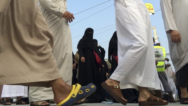 Muslim pilgrims make their way to throw stones at a pillar, symbolizing the stoning of Satan in a ritual called Jamarat, the last rite of the annual hajj, in the Mina neighborhood of Mecca, Saudi Arabia, Sunday, Oct. 5, 2014 - Sputnik International