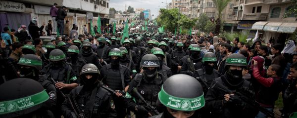 Palestinian Hamas masked gunmen display their military skills during a rally to commemorate the 27th anniversary of the Hamas militant group, in Gaza City, Sunday, Dec. 14, 2014 Palestinian Hamas masked gunmen display their military skills during a rally to commemorate the 27th anniversary of the Hamas militant group, in Gaza City, Sunday, Dec. 14, 2014 - Sputnik International
