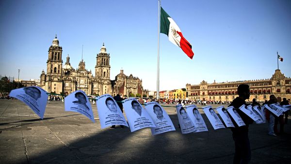 Leaflets with the images of 43 missing students from the state of Guerrero, are shown before a massive protest march, at the Zocalo in Mexico City - Sputnik International