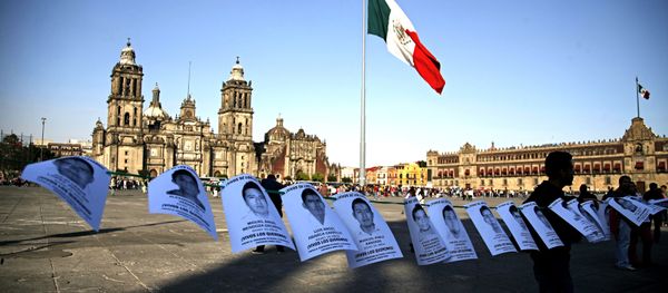 Leaflets with the images of 43 missing students from the state of Guerrero, are shown before a massive protest march, at the Zocalo in Mexico City - Sputnik International