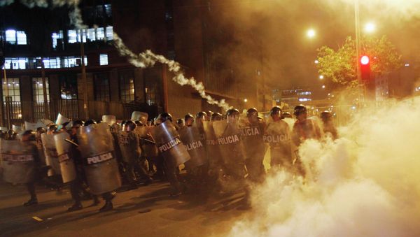 Riot police throw tear gas canisters at protesters during a march against the government's new Youth Labour Law in Lima - Sputnik International