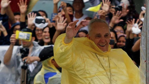 Pope Francis smiles as he waves to residents during a motorcade in Tacloban city, after holding a mass near the airport, January 17, 2015 Pope Francis smiles as he waves to residents during a motorcade in Tacloban city, after holding a mass near the airport, January 17, 2015 - Sputnik International