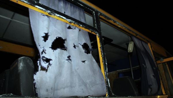 A view of the shattered windows and the torn curtains of a bus hit during shelling - Sputnik International