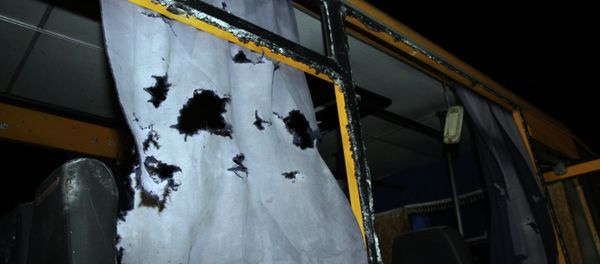 A view of the shattered windows and the torn curtains of a bus hit during shelling - Sputnik International