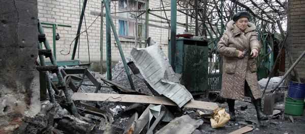A woman looks at debris in front of a house, which according to locals, was recently damaged by shelling, in Donetsk, eastern Ukraine, January 17, 2015 A woman looks at debris in front of a house, which according to locals, was recently damaged by shelling, in Donetsk, eastern Ukraine, January 17, 2015 - Sputnik International
