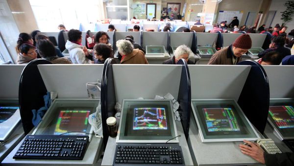 Investors look at computer screens showing stock information at a brokerage house in Shanghai - Sputnik International