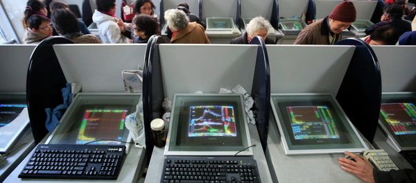 Investors look at computer screens showing stock information at a brokerage house in Shanghai - Sputnik International