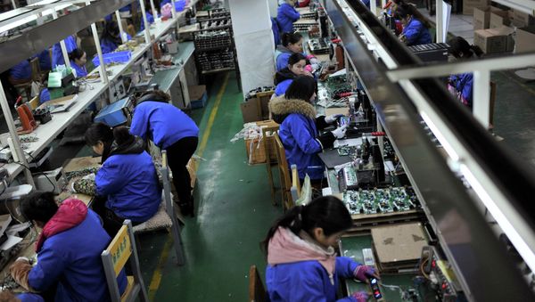 Employees assemble electronic components Employees assemble electronic components - Sputnik International