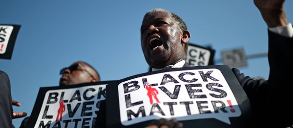Men holding signs reading Black Lives Matter march in the 30th annual Kingdom Day Parade in honor of Dr. Martin Luther King Jr. Men holding signs reading Black Lives Matter march in the 30th annual Kingdom Day Parade in honor of Dr. Martin Luther King Jr. - Sputnik International