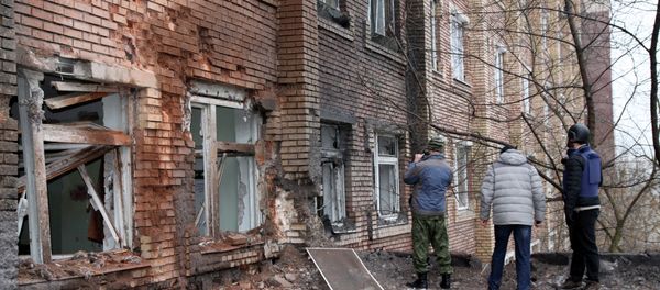 Journalists stand in front of a hospital destroyed after shelling between Ukrainian forces and pro-Russian separatists in the eastern Ukrainian city of Donetsk Journalists stand in front of a hospital destroyed after shelling between Ukrainian forces and pro-Russian separatists in the eastern Ukrainian city of Donetsk - Sputnik International