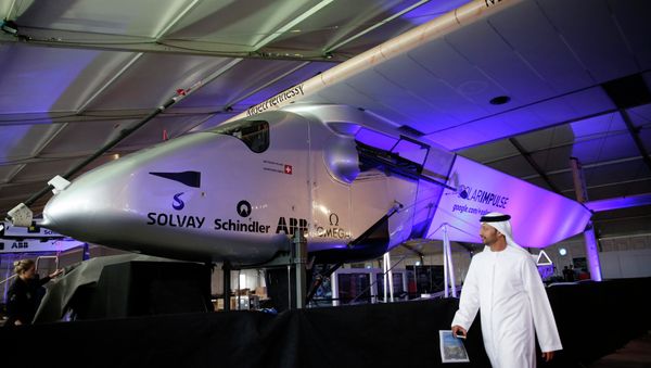 A man walks past the Solar Impulse 2 during its presentation at the Al Bateen airport in Abu Dhabi January 20, 2015. A man walks past the Solar Impulse 2 during its presentation at the Al Bateen airport in Abu Dhabi January 20, 2015. - Sputnik International