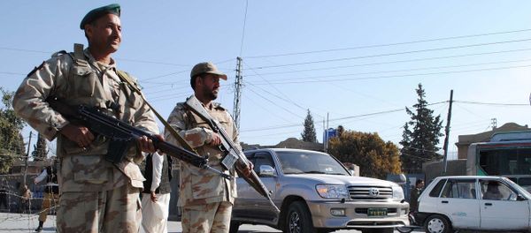 Security members stand guard on the road , Pakistan - Sputnik International
