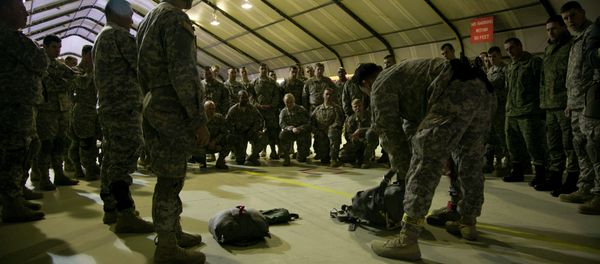 US Army soldiers of the 4th Infantry Brigade, Combat team (Airborne) 25th Infantry Division, part of the NATO-led peacekeeping mission in Kosovo listen to jump master how to prepare their gear for a parachute training exercise in US military base Camp Bondsteel, near the village of Sojeve in Kosovo on Sunday, Dec. 21, 2014 US Army soldiers of the 4th Infantry Brigade, Combat team (Airborne) 25th Infantry Division, part of the NATO-led peacekeeping mission in Kosovo listen to jump master how to prepare their gear for a parachute training exercise in US military base Camp Bondsteel, near the village of Sojeve in Kosovo on Sunday, Dec. 21, 2014 - Sputnik International