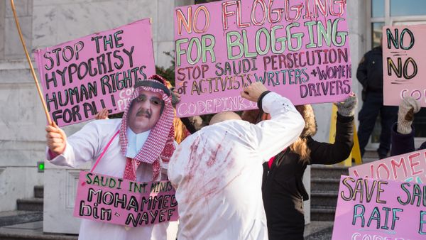Protesters simulate a flogging in front of the Saudi embassy in Washington,DC on January 15, 2015 during a demonstration against the 10-year prison sentence and 1,000 lashes of Saudi activist Raef Badawi for insulting Islam in a blogpost Protesters simulate a flogging in front of the Saudi embassy in Washington,DC on January 15, 2015 during a demonstration against the 10-year prison sentence and 1,000 lashes of Saudi activist Raef Badawi for insulting Islam in a blogpost - Sputnik International