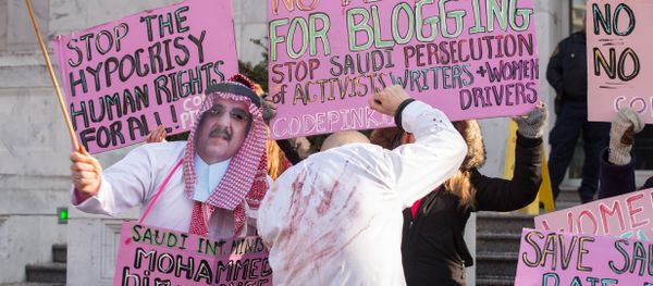 Protesters simulate a flogging in front of the Saudi embassy in Washington,DC on January 15, 2015 during a demonstration against the 10-year prison sentence and 1,000 lashes of Saudi activist Raef Badawi for insulting Islam in a blogpost Protesters simulate a flogging in front of the Saudi embassy in Washington,DC on January 15, 2015 during a demonstration against the 10-year prison sentence and 1,000 lashes of Saudi activist Raef Badawi for insulting Islam in a blogpost - Sputnik International
