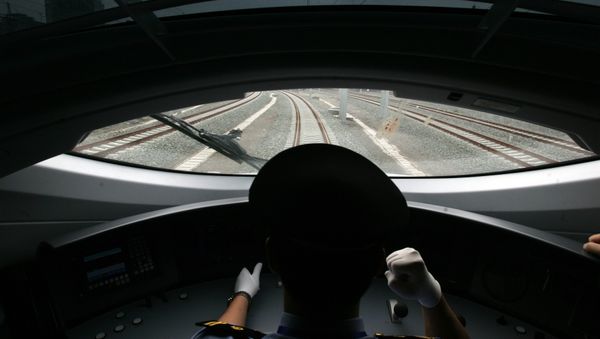 A Chinese train driver takes the new bullet train on a test run on the new high-speed Beijing-Tianjin express railway in Beijing on June 26, 2008 - Sputnik International
