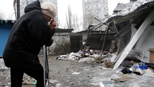 A woman reacts as she stands at a market, which according to locals was recently damaged by shelling, in Donetsk, eastern Ukraine January 19, 2015 - Sputnik International