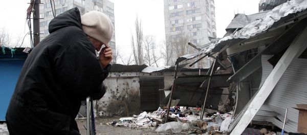 A woman reacts as she stands at a market, which according to locals was recently damaged by shelling, in Donetsk, eastern Ukraine January 19, 2015 A woman reacts as she stands at a market, which according to locals was recently damaged by shelling, in Donetsk, eastern Ukraine January 19, 2015 - Sputnik International