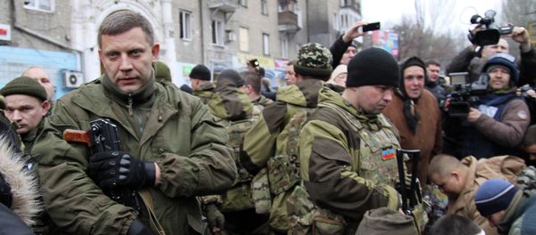Leader of the self-declared Donetsk People's Republic Alexander Zakharchenko (L) stands next to kneeling captive Ukrainian soldiers at a bus stop where 13 people were killed in a trolleybus shelling in Donetsk, eastern Ukraine, on January 22, 2015 Leader of the self-declared Donetsk People's Republic Alexander Zakharchenko (L) stands next to kneeling captive Ukrainian soldiers at a bus stop where 13 people were killed in a trolleybus shelling in Donetsk, eastern Ukraine, on January 22, 2015 - Sputnik International