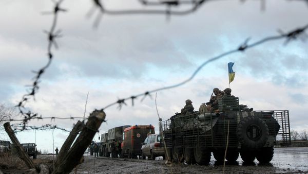 A Ukrainian military convoy is pictured through a barbed wire fence at a military base in the town of Kramatorsk, eastern Ukraine A Ukrainian military convoy is pictured through a barbed wire fence at a military base in the town of Kramatorsk, eastern Ukraine - Sputnik International
