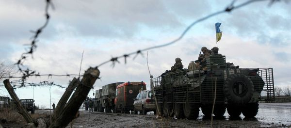 A Ukrainian military convoy is pictured through a barbed wire fence at a military base in the town of Kramatorsk, eastern Ukraine A Ukrainian military convoy is pictured through a barbed wire fence at a military base in the town of Kramatorsk, eastern Ukraine - Sputnik International