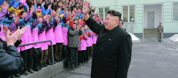 North Korean leader Kim Jong Un waves to a crowd as he provides field guidance to the Ryuwon Shoes Factory in this undated photo released by North Korea's Korean Central News Agency (KCNA) in Pyongyang January 21, 2015 - Sputnik International