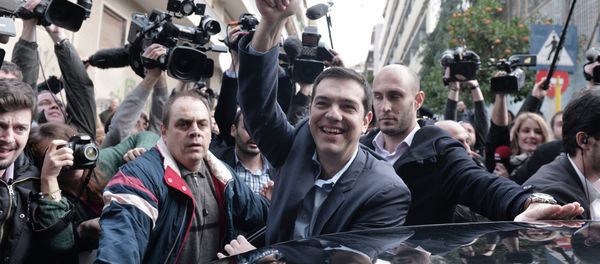 The leader of Greece's left-wing Syriza party Alexis Tsipras waves as he leaves after voting at a polling station in Athens on January, 2015 - Sputnik International