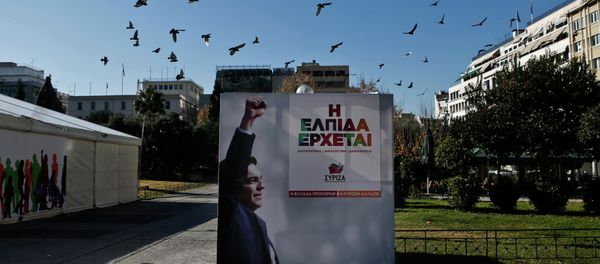 A flock of pigeons flies over a banner with an image of opposition leader and head of radical leftist Syriza party Alexis Tsipras at the party's pre-election kiosk in Athens January 15, 2015. A flock of pigeons flies over a banner with an image of opposition leader and head of radical leftist Syriza party Alexis Tsipras at the party's pre-election kiosk in Athens January 15, 2015. - Sputnik International