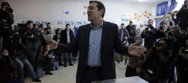 Alexis Tsipras, leader of Greece's Syriza left-wing main opposition party surrounded by photographers reacts as he casts his vote at a polling station in Athens, Sunday, Jan. 25, 2015 Alexis Tsipras, leader of Greece's Syriza left-wing main opposition party surrounded by photographers reacts as he casts his vote at a polling station in Athens, Sunday, Jan. 25, 2015 - Sputnik International