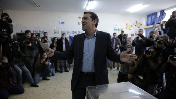 Alexis Tsipras, leader of Greece's Syriza left-wing main opposition party surrounded by photographers reacts as he casts his vote at a polling station in Athens, Sunday, Jan. 25, 2015 Alexis Tsipras, leader of Greece's Syriza left-wing main opposition party surrounded by photographers reacts as he casts his vote at a polling station in Athens, Sunday, Jan. 25, 2015 - Sputnik International
