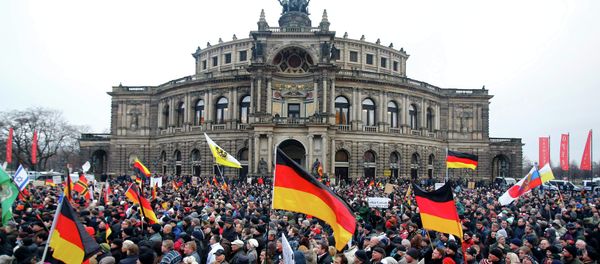 Members of the movement of Patriotic Europeans Against the Islamisation of the West (PEGIDA) hold flags and banners during a PEGIDA demonstration march in Dresden Members of the movement of Patriotic Europeans Against the Islamisation of the West (PEGIDA) hold flags and banners during a PEGIDA demonstration march in Dresden - Sputnik International