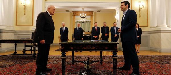 Head of radical leftist Syriza party and winner of the Greek parliamentary elections Alexis Tsipras (R) stands in front of Greek President Karolos Papoulias in the Presidential Palace in Athens during a swearing in ceremony as Greece's first leftist Prime Minister - Sputnik International