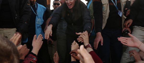 US actress and UNHCR ambassador Angelina Jolie (C) greets displaced Iraqi children during a visit to a camp for displaced people in Khanke, a few kilometres (miles) from the Turkish border in Iraq's Dohuk province US actress and UNHCR ambassador Angelina Jolie (C) greets displaced Iraqi children during a visit to a camp for displaced people in Khanke, a few kilometres (miles) from the Turkish border in Iraq's Dohuk province - Sputnik International