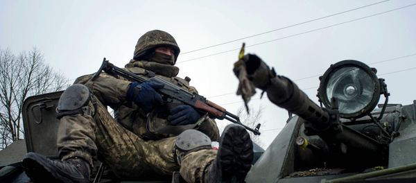 A Ukrainian serviceman rides on APC A Ukrainian serviceman rides on APC - Sputnik International