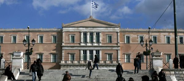 People make their way in central Syntagma Square as the parliament building is pictured in the background in Athens People make their way in central Syntagma Square as the parliament building is pictured in the background in Athens - Sputnik International