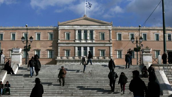 People make their way in central Syntagma Square as the parliament building is pictured in the background in Athens People make their way in central Syntagma Square as the parliament building is pictured in the background in Athens - Sputnik International
