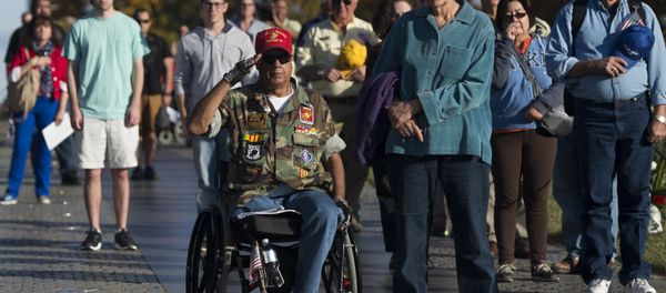 Vietnam War veteran Joe Caballero (C) salutes during the playing of Taps at the Vietnam Veterans Memorial wall on the National Mall in Washington, DC Vietnam War veteran Joe Caballero (C) salutes during the playing of Taps at the Vietnam Veterans Memorial wall on the National Mall in Washington, DC - Sputnik International