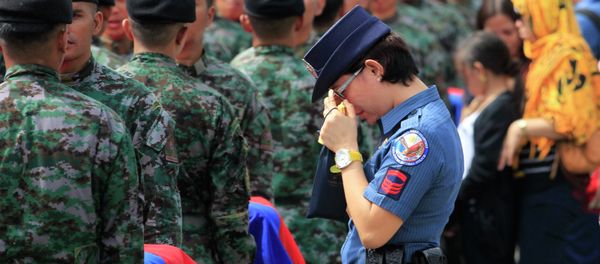 A policewoman wipes her tears as she stands in front of metal caskets containing the bodies of Special Action Force (SAF) police who were killed in Sunday's clash with Muslim rebels, at Villamor Air Base in Pasay city, metro Manila January 29, 2015 A policewoman wipes her tears as she stands in front of metal caskets containing the bodies of Special Action Force (SAF) police who were killed in Sunday's clash with Muslim rebels, at Villamor Air Base in Pasay city, metro Manila January 29, 2015 - Sputnik International