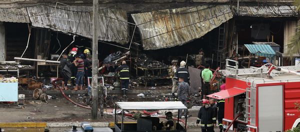 Security forces inspect the site of a twin bombing at a crowded market in Baghdad Iraq, Friday - Sputnik International