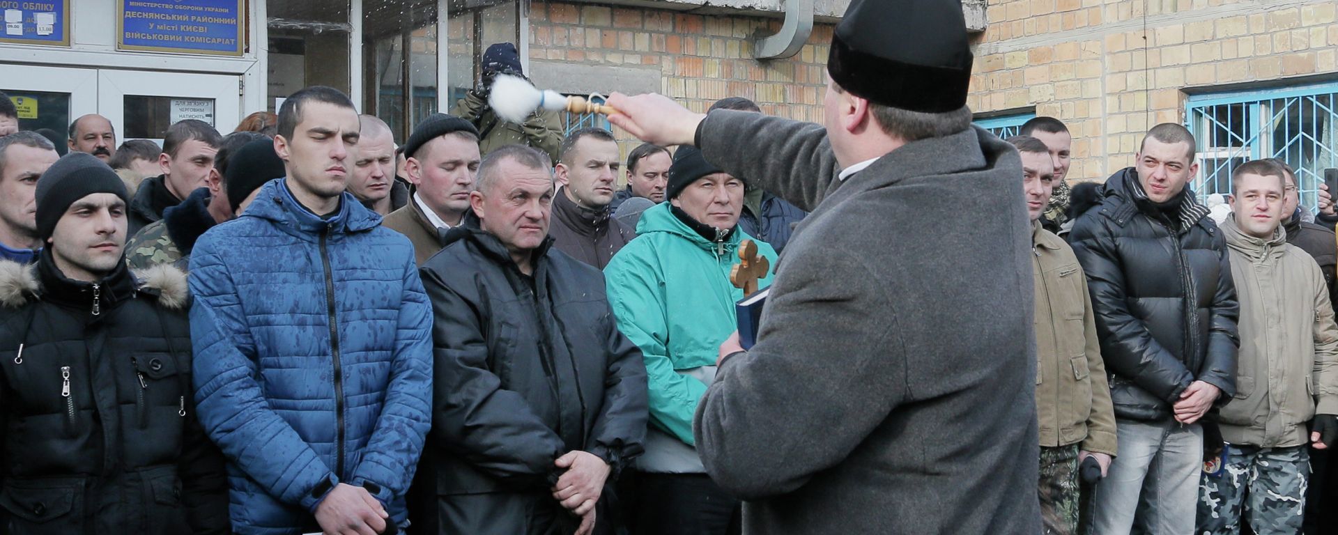 A priest blesses newly-mobilized recruits in front of a military registration office before they leave for military units, in Kiev, Ukraine, Thursday, Jan.29, 2015 A priest blesses newly-mobilized recruits in front of a military registration office before they leave for military units, in Kiev, Ukraine, Thursday, Jan.29, 2015 - Sputnik International, 1920, 14.08.2023