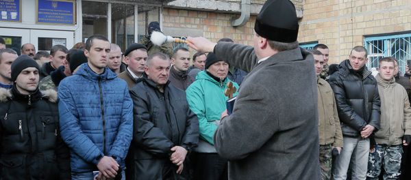 A priest blesses newly mobilized recruits in front of a military registration office before they leave for military units, in Kiev, Ukraine, Thursday, Jan.29, 2015 - Sputnik International